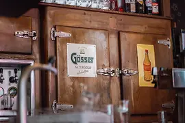 Close-up of a wooden refrigerator cabinet behind the bar at Heidingers Gasthaus.