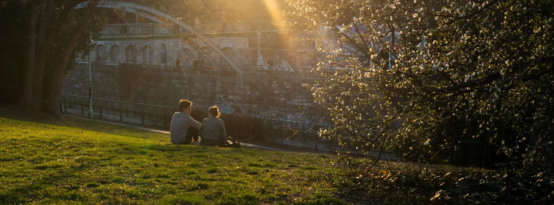 A couple sits in the city park enjoying the spring atmosphere