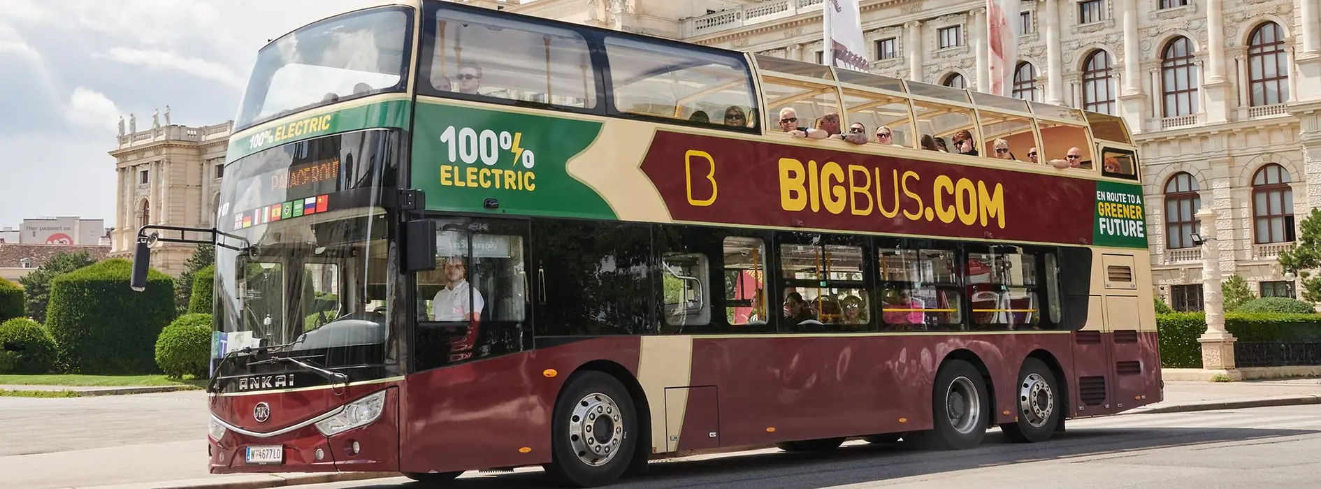 Red electric hop-on hop-off double-decker bus by Big Bus Tours in front of the Natural History Museum Vienna