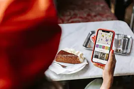 Woman with cell phone and a Sachertorte