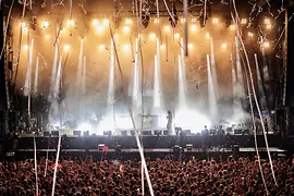 Koncertní pódium s světelnou show a davem lidí na festivalu Donauinselfest