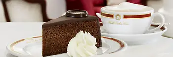 A slice of Sacher-Torte with whipped cream
