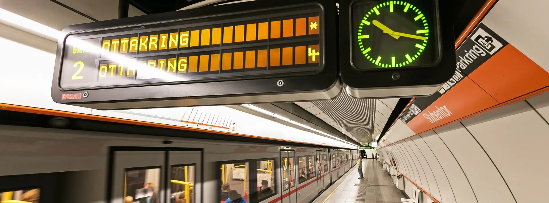 Information panel in the Vienna subway with clock
