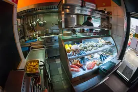 Umarfisch at Naschmarkt, interior shot with a view of fresh fish and the kitchen 