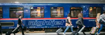 ÖBB Nightjet in the station with travelers in the foreground