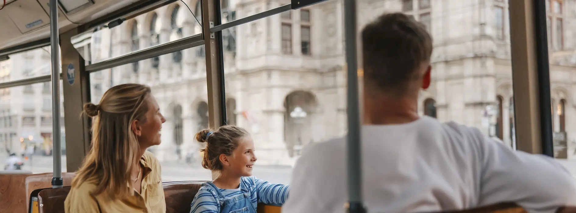 Family with child in tram in front of the Vienna State Opera