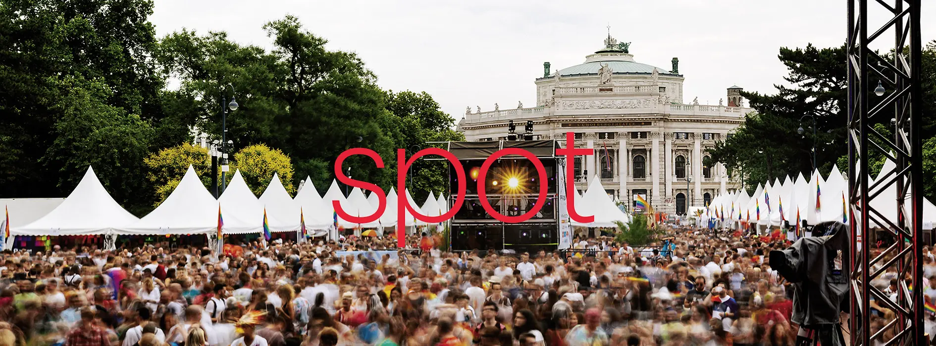 Spot is written in large red letters in the middle of the picture, the name of the event brochure, the picture shows an event in front of the Burgtheater