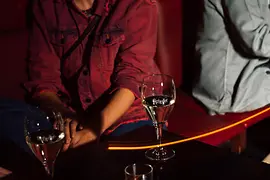 People with drinks at the bar of the Marea Alta