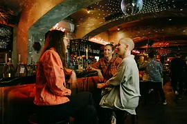 Three women at the bar of Motto