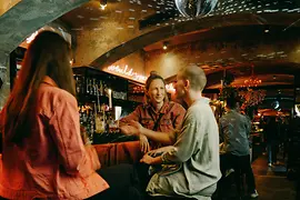 Three women at the bar of Motto