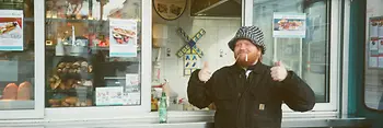 Chef Lukas Mraz in front of a sausage stand