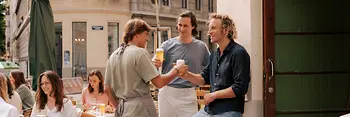 People in front of the entrance to a bar