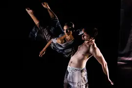 A male dancer lifts a female dancer