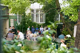 People sitting in a garden with food and drink