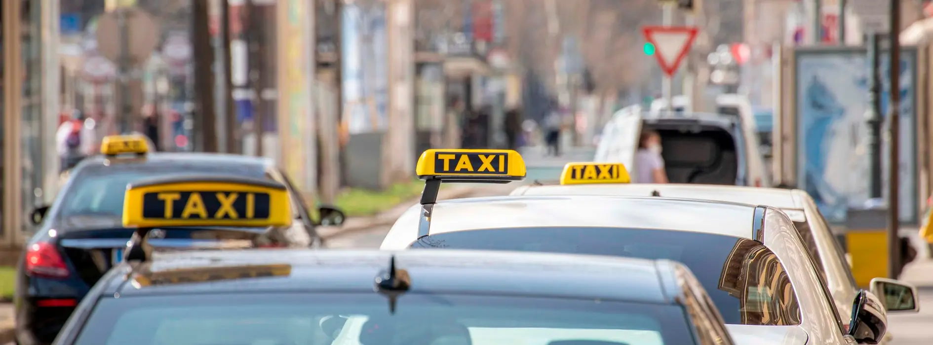 Cab rank in Vienna on the Ringstrasse with several cabs with signs (black with yellow lettering)